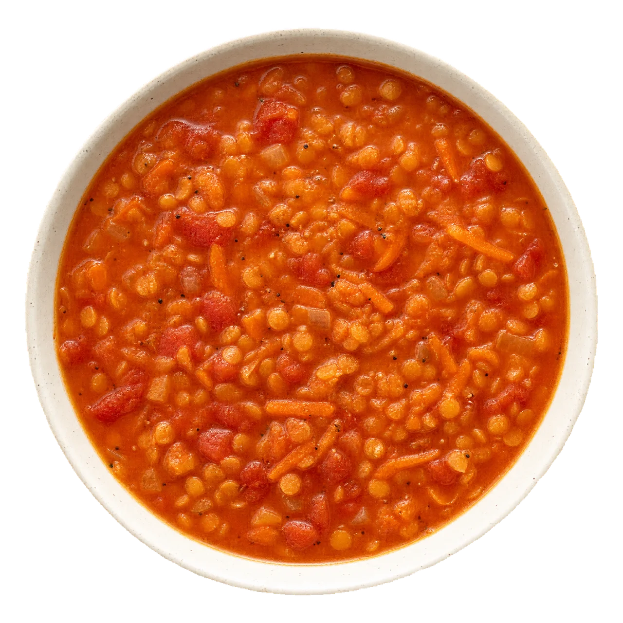 Thick orange-red lentil, tomato and carrot soup in a pale bowl.