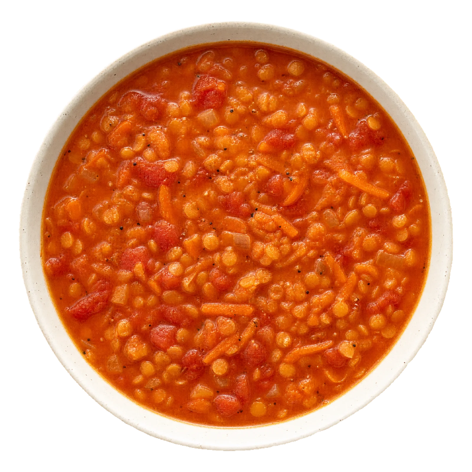Thick orange-red lentil, tomato and carrot soup in a pale bowl.